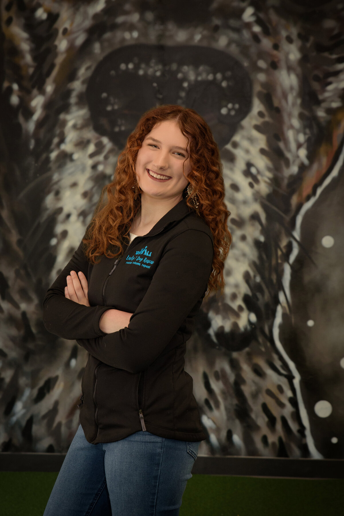 Green Bay East High School senior girl with red curly hair at Lucky Seven dog rescue in urban setting in downtown Green Bay, Wisconsin.  Animal lover.