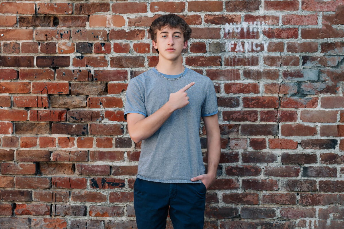 Boy poses in urban setting in Prescott senior photos