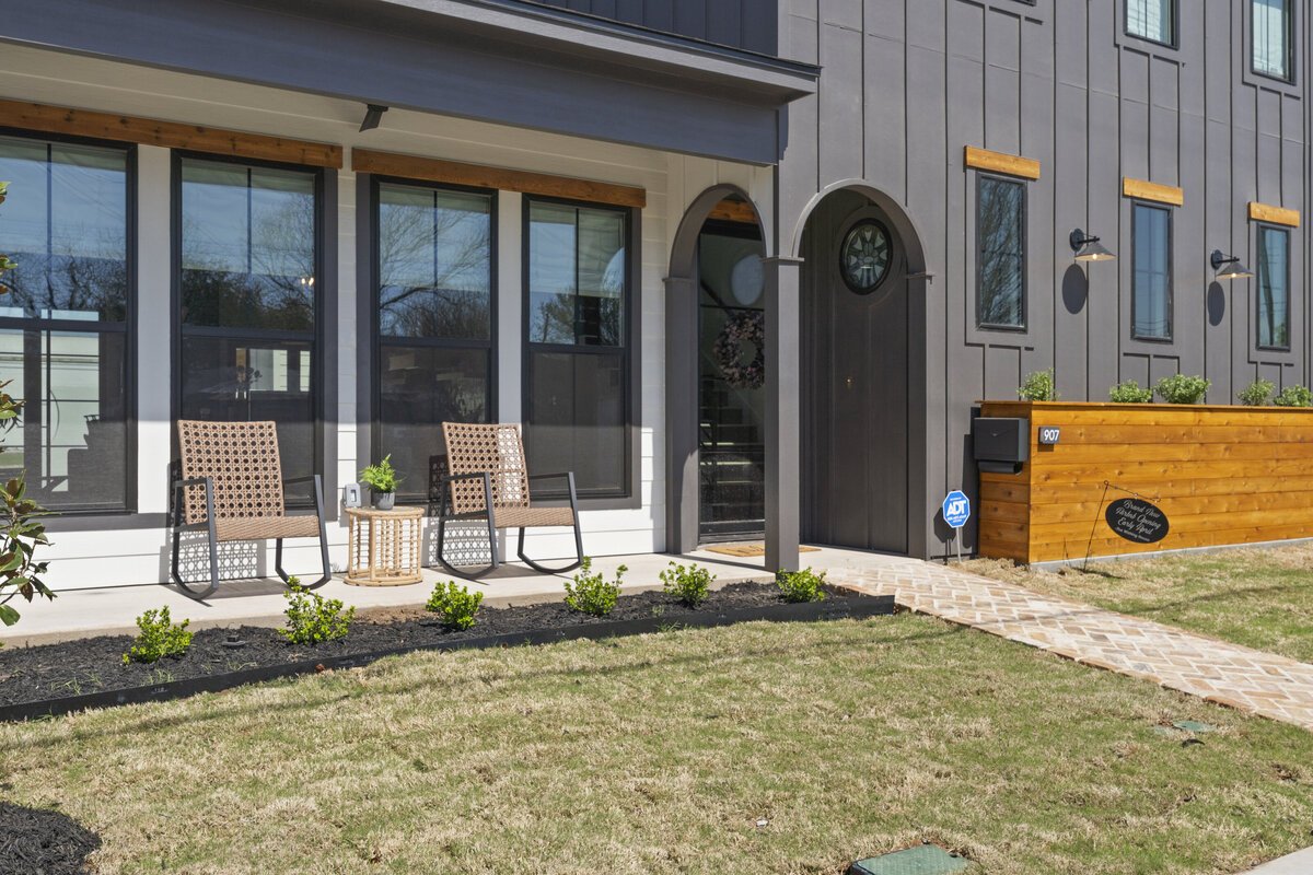 Charming patio seating area at this two-bedroom, two-bathroom house with wine fridge, firepit, and two master suites located in the heart of the Silo District in Waco, TX.