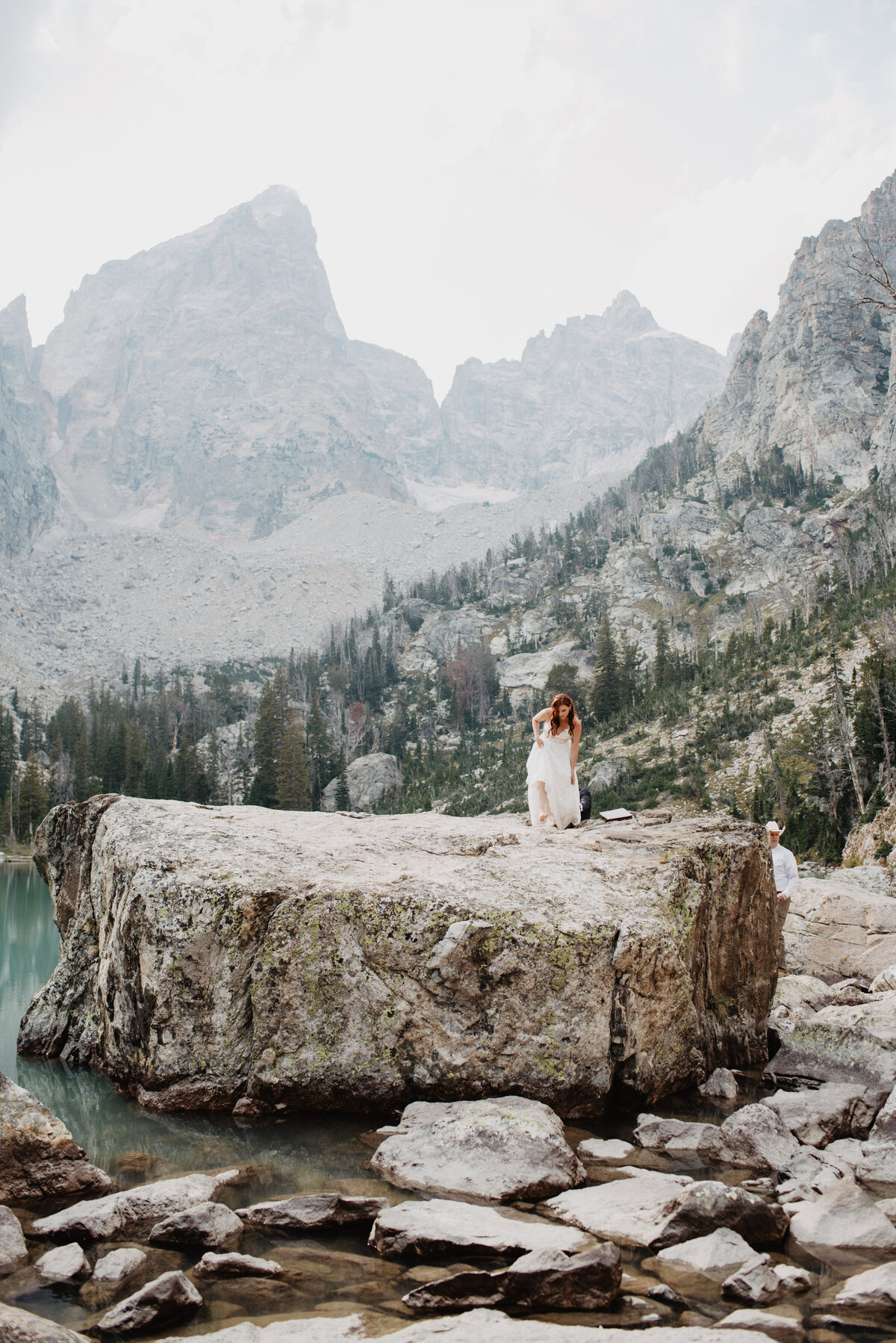 Jackson Hole photographers capture bride walking on boulder in Grand Teton National Park