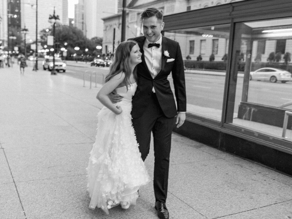 Newlyweds walk along Michigan Avenue in downtown Chicago on their wedding day