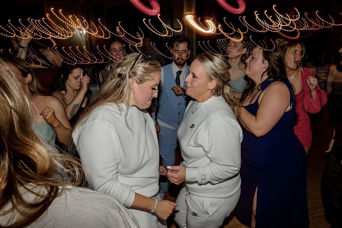 Bride and Bride dancing. with swirling lights at their colorado wedding