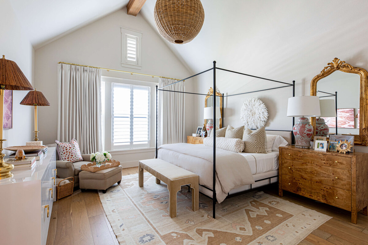 oyster creek studios aryns home canopy bed with tan bedding and chair in bedroom