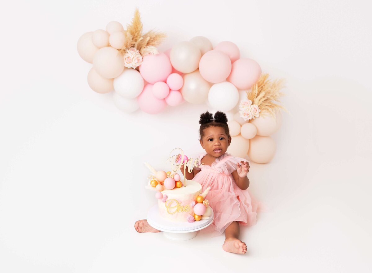 Cake smash photography session in NYC, capturing the magic of a baby’s first birthday with vibrant colors, custom cakes, and fun props. Ideal for parents seeking high-quality birthday photoshoots in New York City