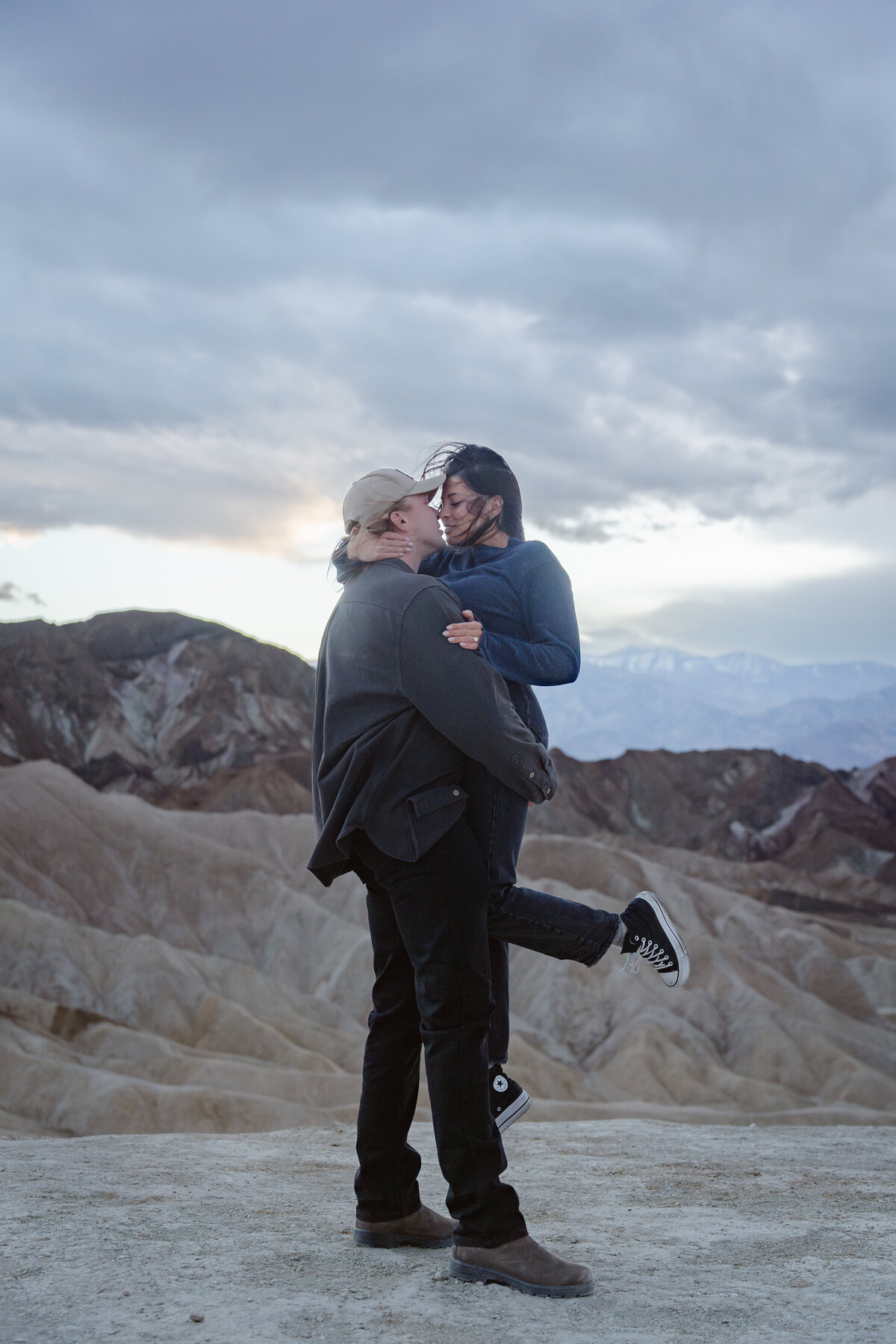 A person holding up their partner as they are about to kiss