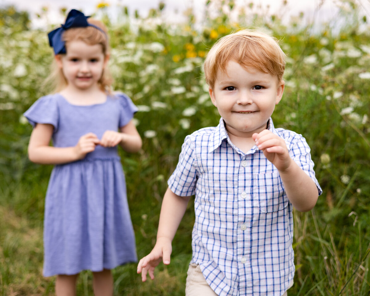 Siblings Playing in the Flowers