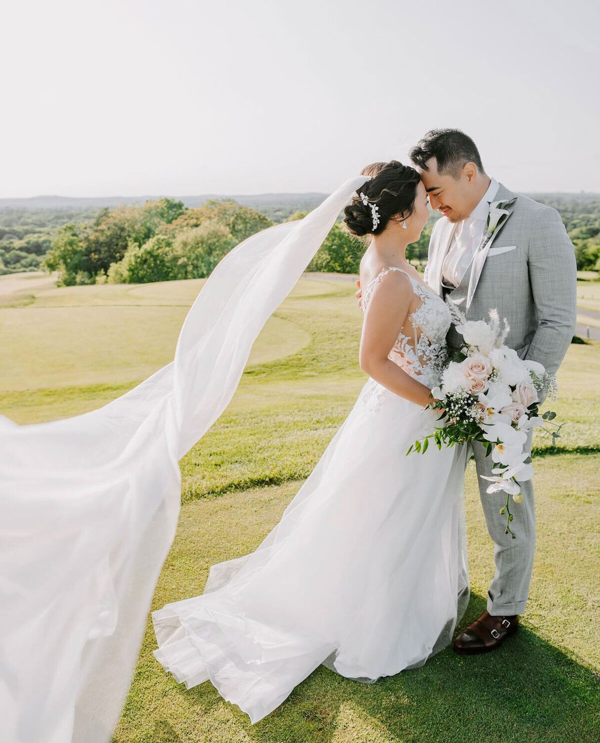 Bride and groom about to kiss in an outdoor area