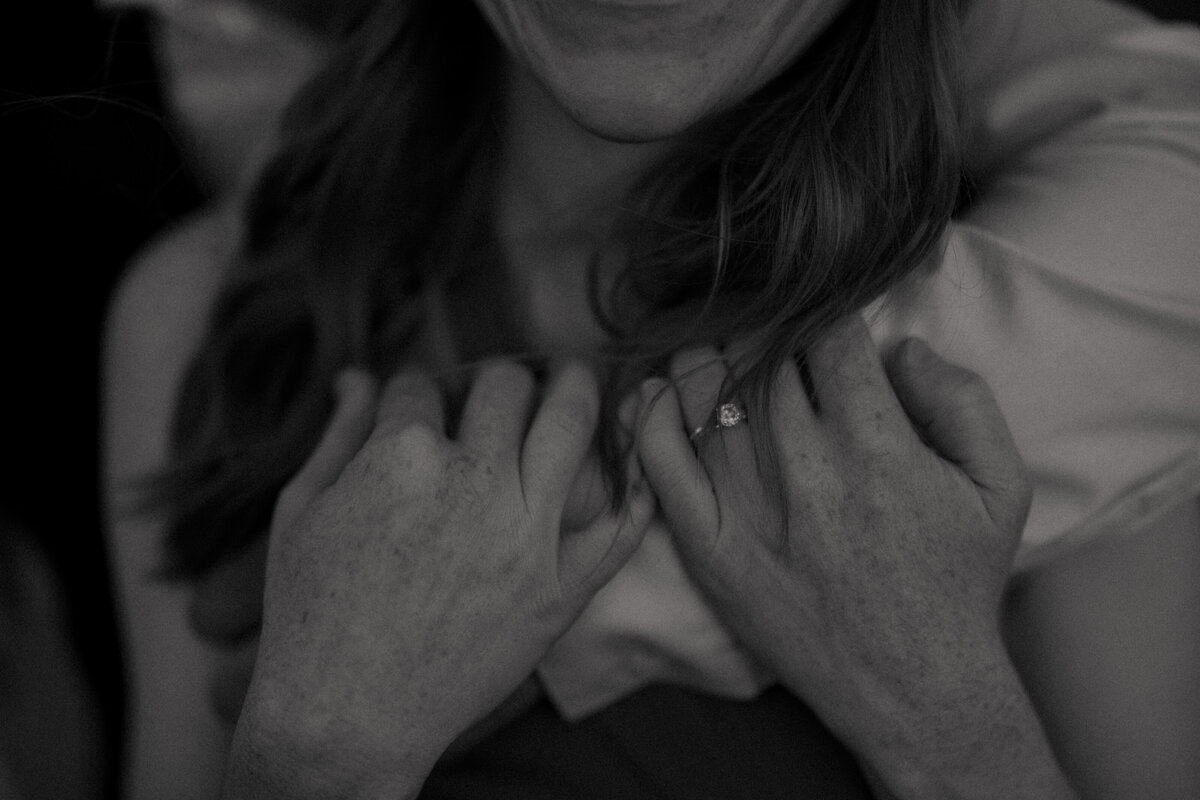 Couple standing against red rock backdrop during Sedona engagement session