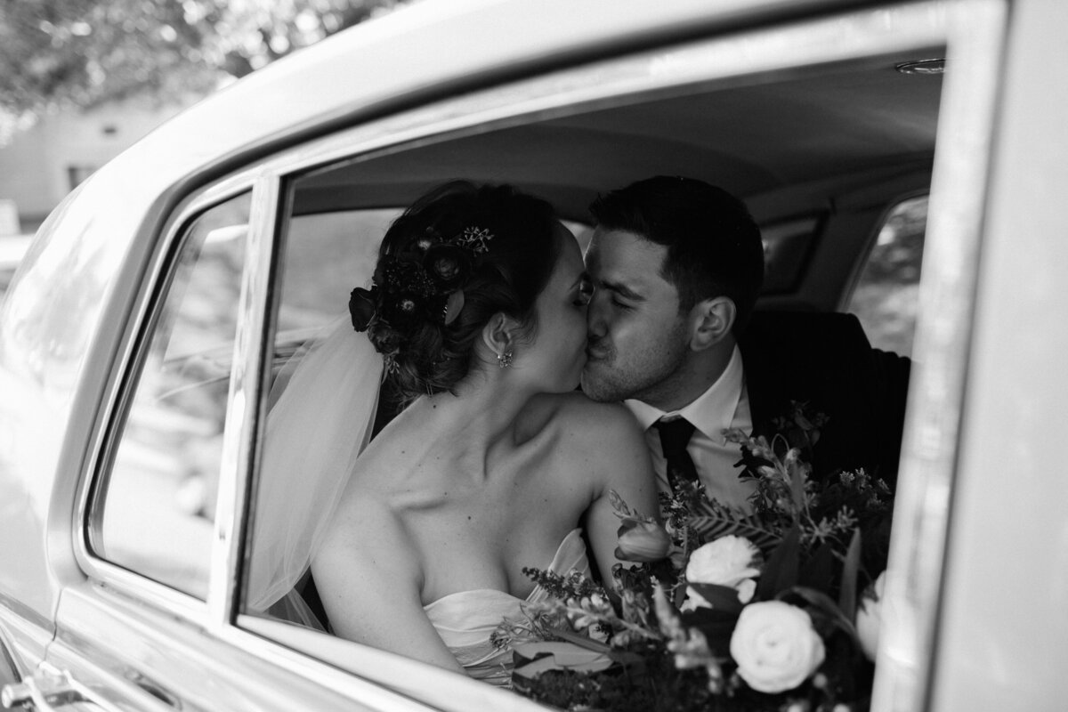 bride and groom in an upscale vintage car at Willowbrook