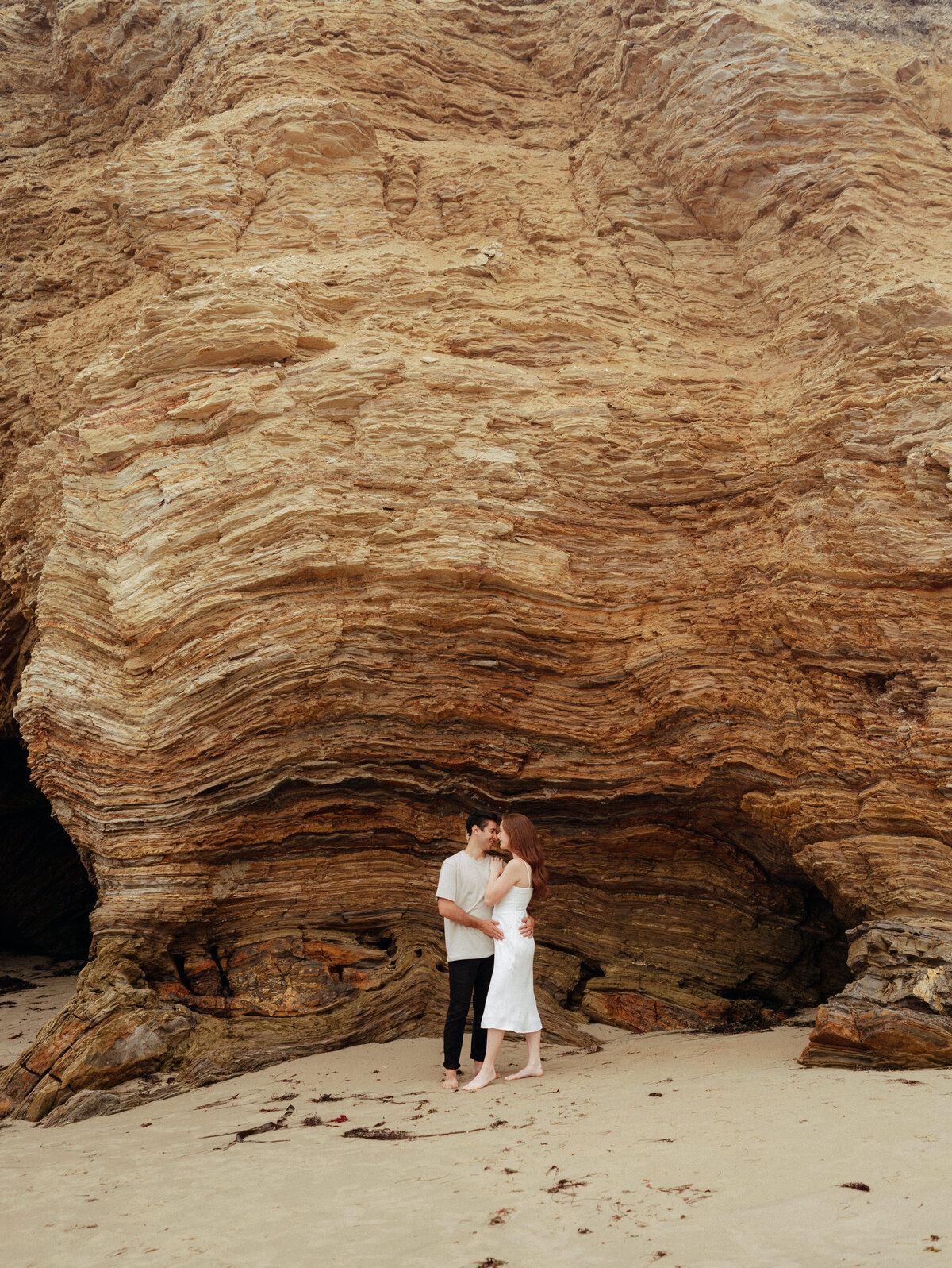 couple shoot for maternity session during golden hour Oregon coast beach wedding/elopement - photographed by The Storytellers