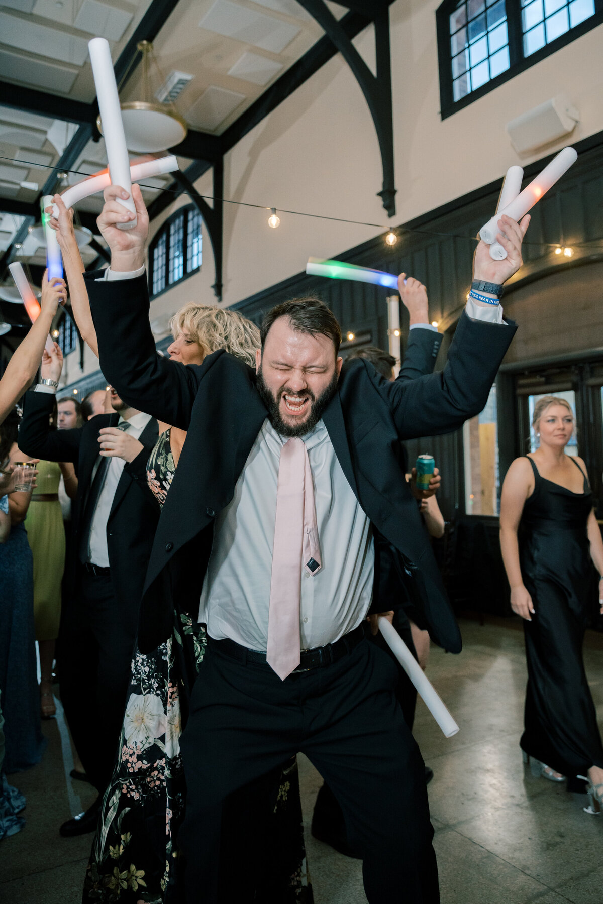 Guests dancing with LED foam sticks at the Bristol Train Station