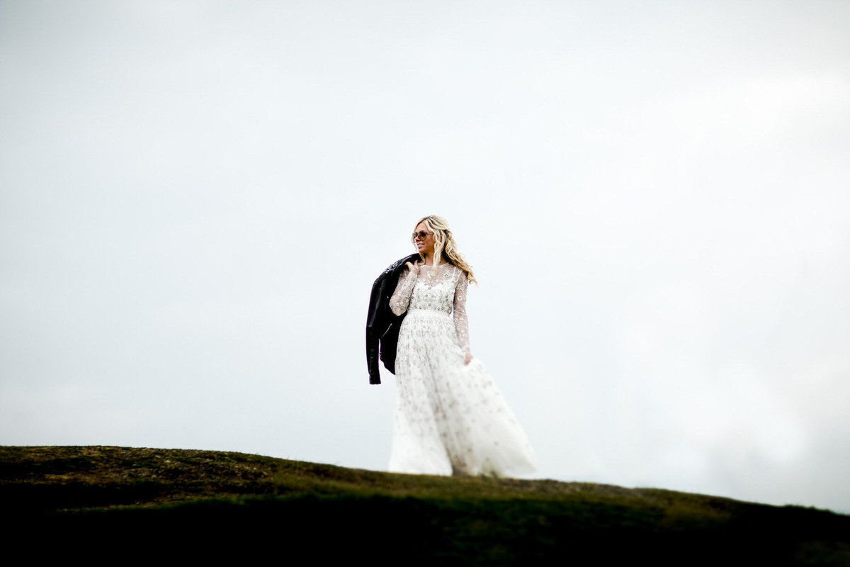 elopement wedding bride with leather jacket on a mountain