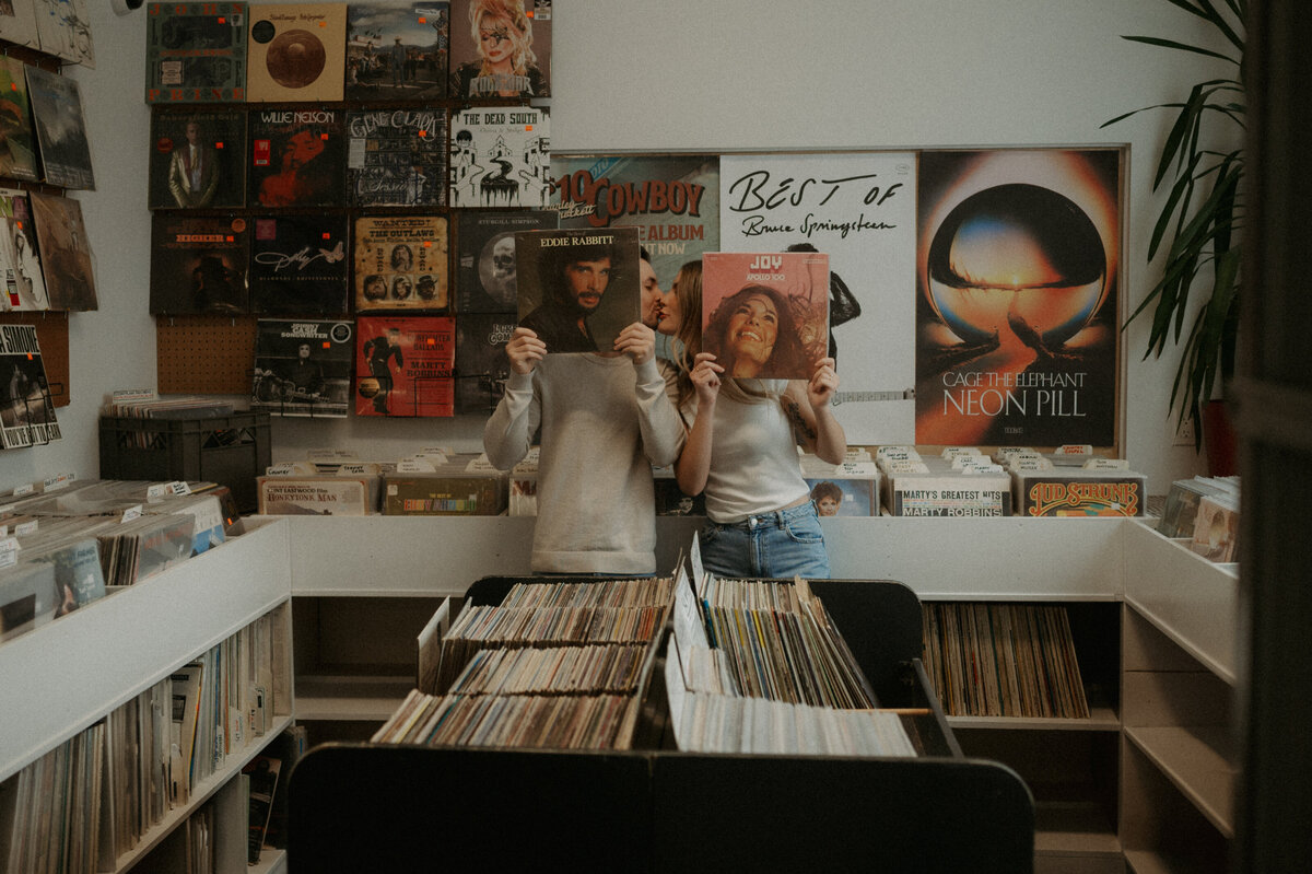 Couple having fun during a photoshoot on a date at the record store