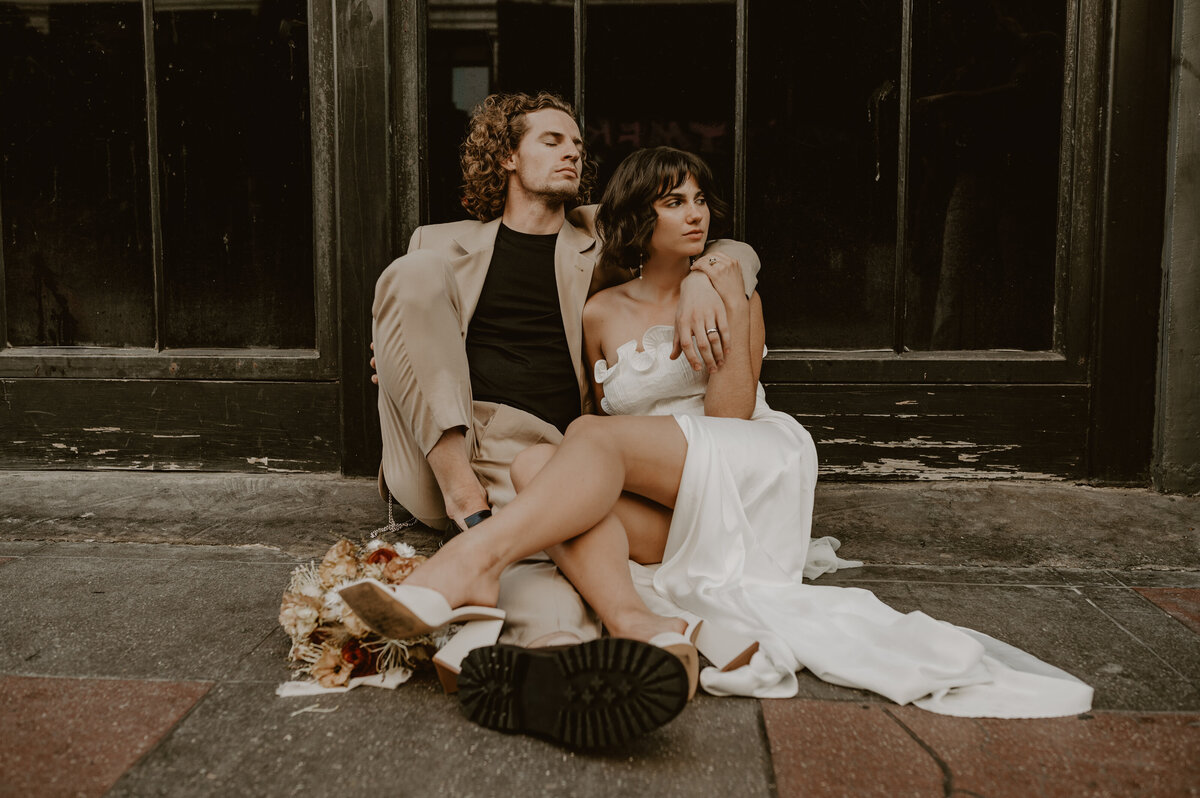couple-sitting-in-wedding-attire-downtown-los-angeles