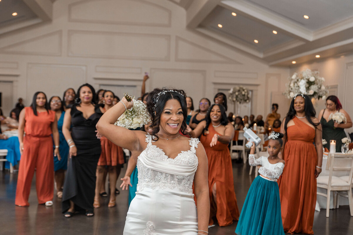 A lively moment as the bride celebrates with her bridesmaids on the dance floor.