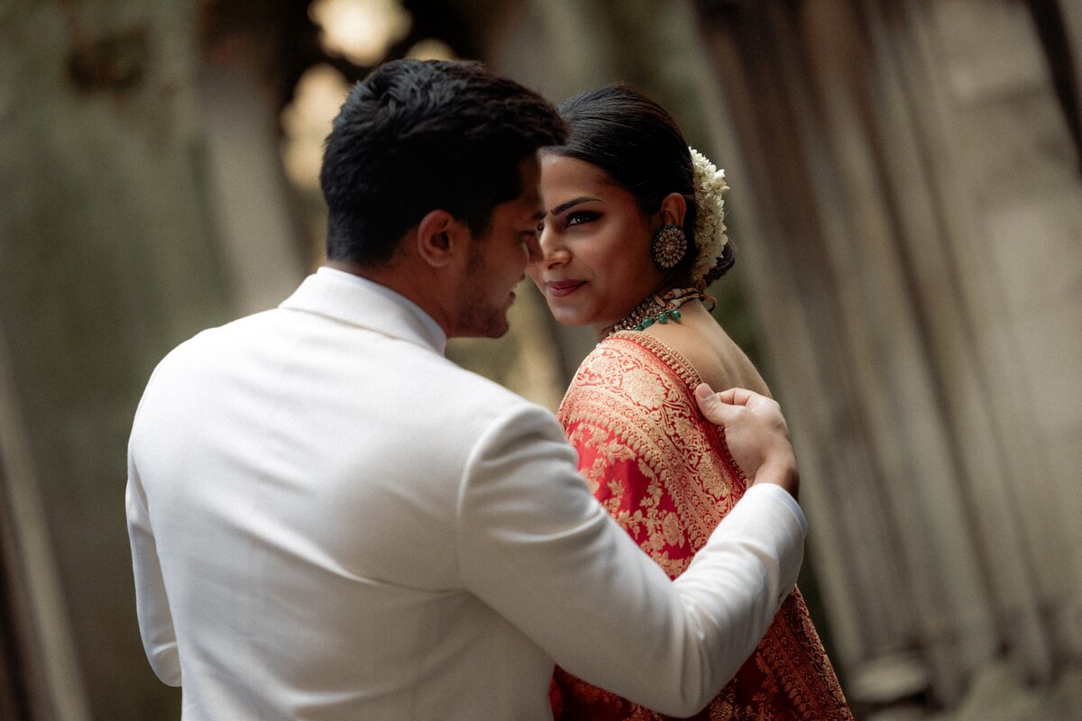A romantic couple getting ready for tehir elopement wedding in St Dunstan in the east garden for London elopement photographer Hadi Photography