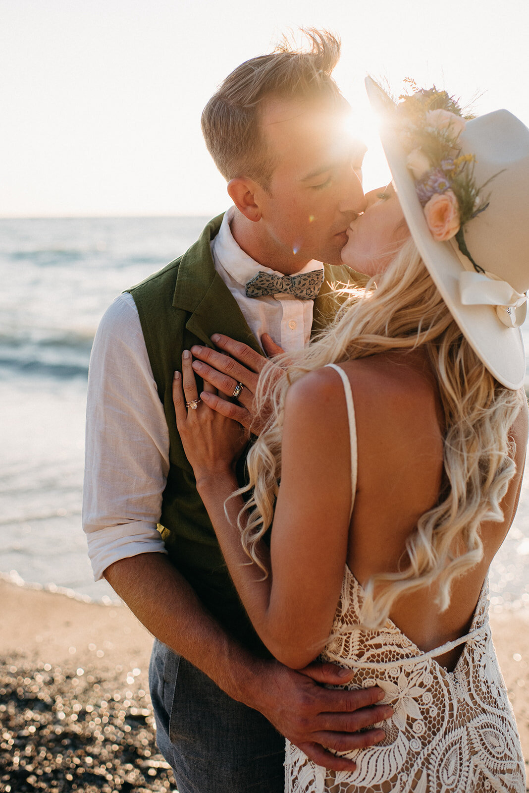 Bride and groom kissing on beach at sunset, captured by Kristin Sarah Photography. Featured on the Bronte Bride Vendor Guide.