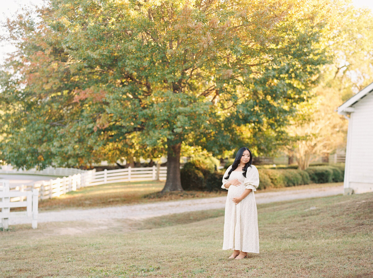 Mom poses underneath a big oak tree during her maternity session at Oak View Park. Image by Raleigh maternity photographer A.J. Dunlap Photography.