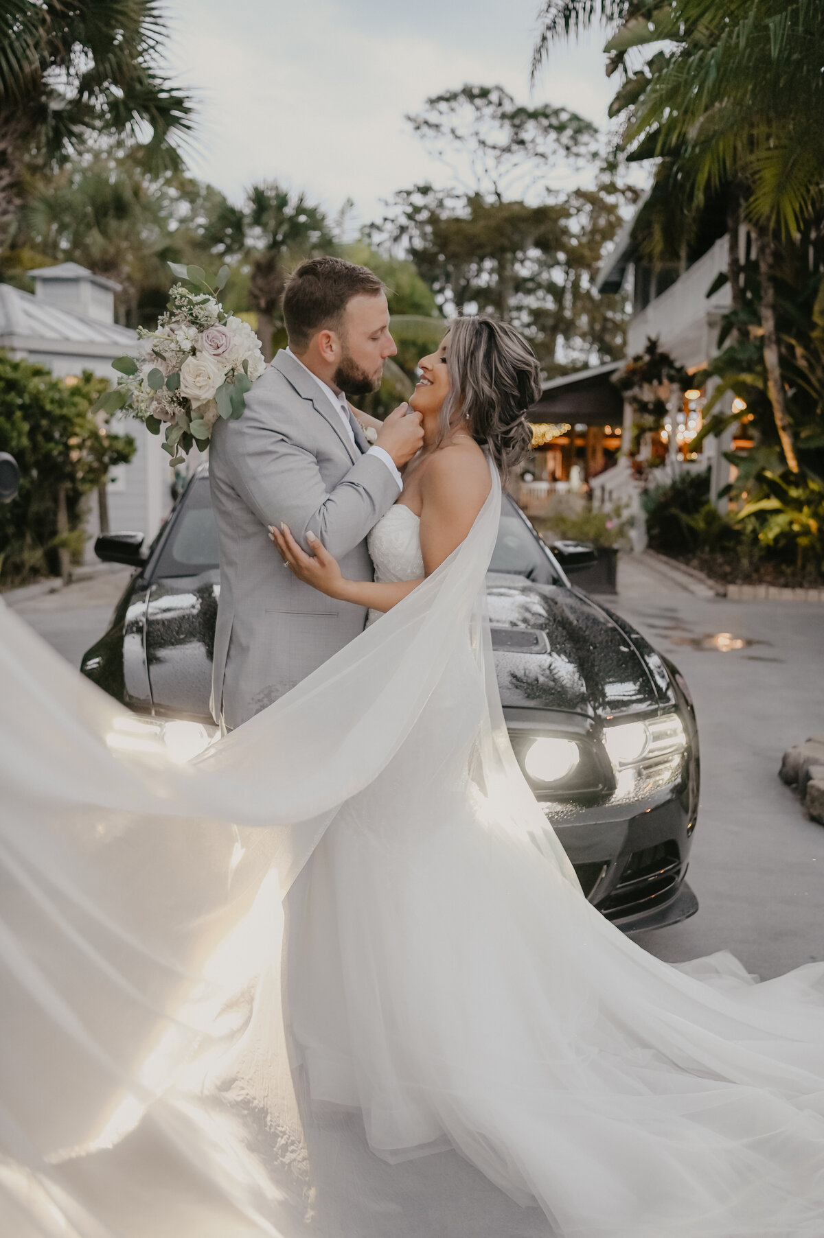 photos with bride and groom in front of car