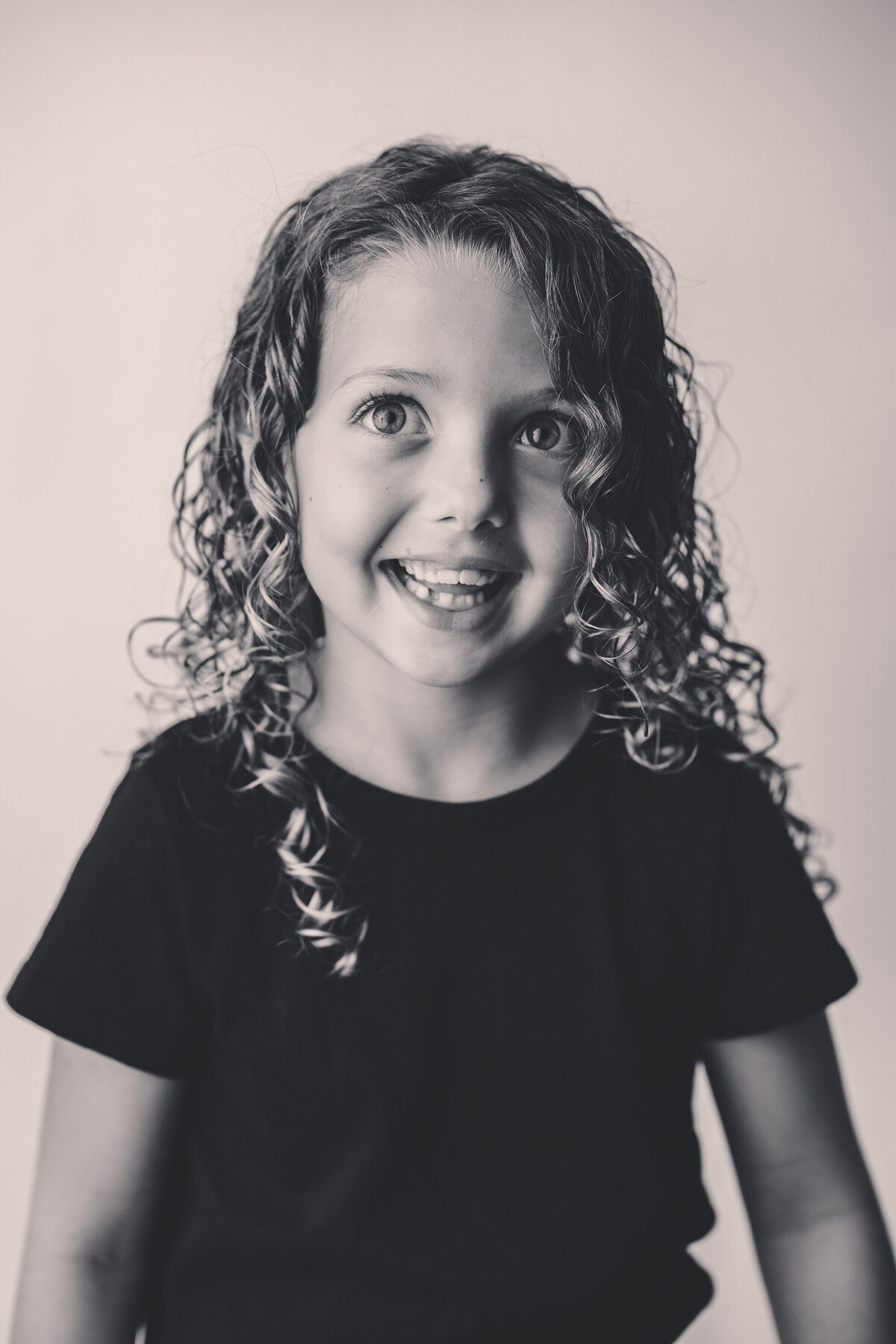 Young girl smiles at the camera during Personality Photoshoot in Charleston, South Carolina.