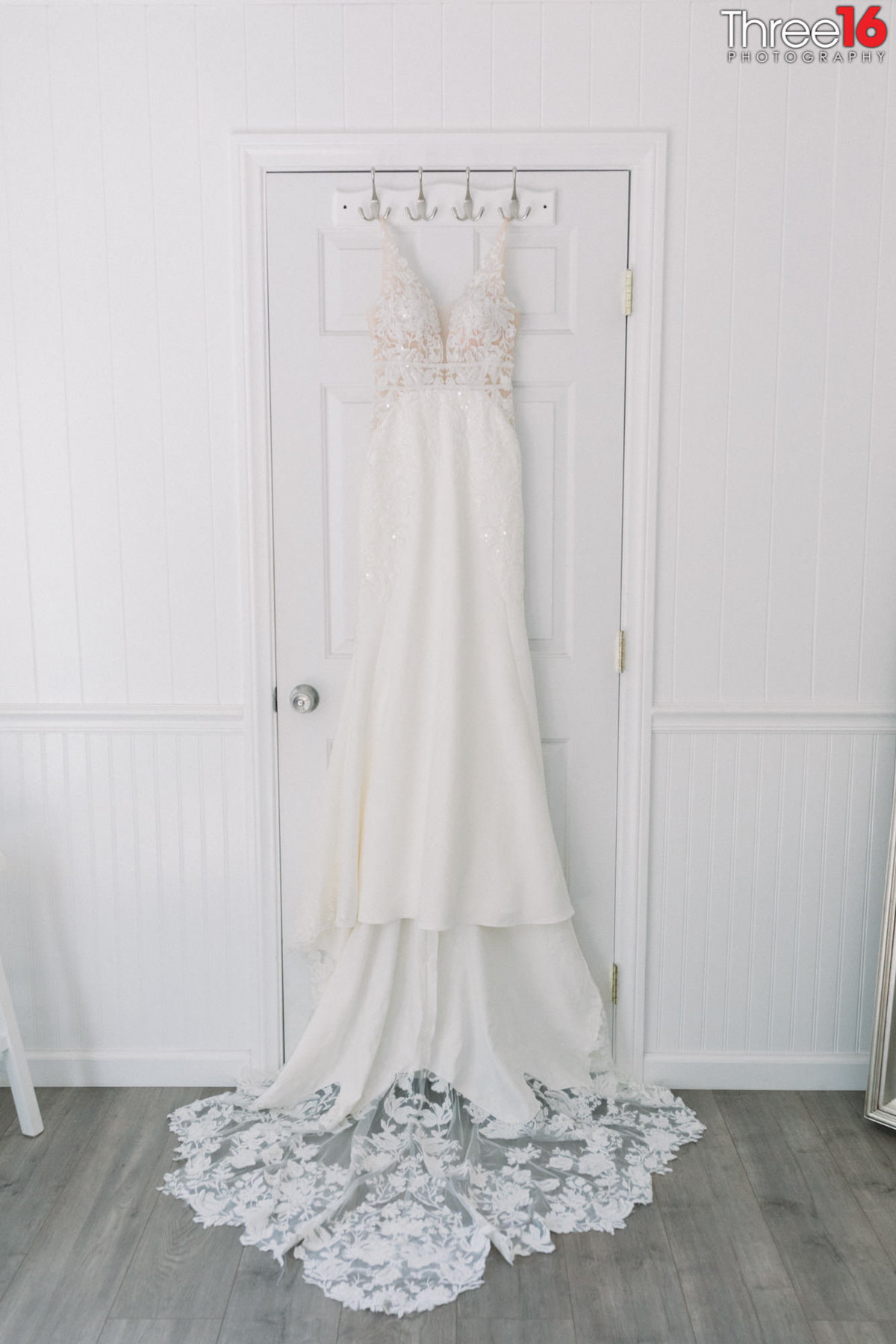 Beautiful wedding dress hanging on closet door