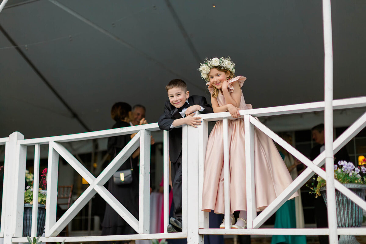 Flower girl and ring bearer standing on the railing on the back deck at The Clifton.