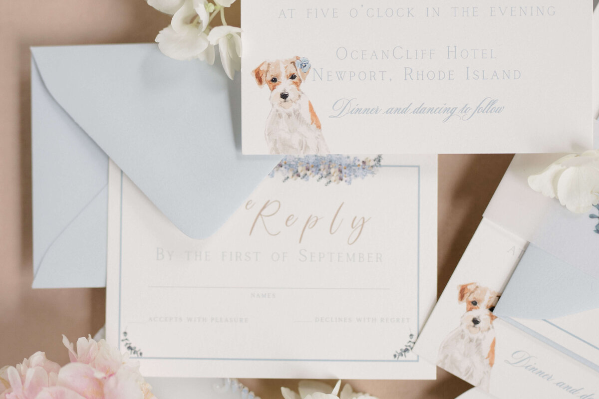 Custom coastal wedding invitation suite with delicate florals, classic typography, and a watercolor dog illustration by White Heart Design.