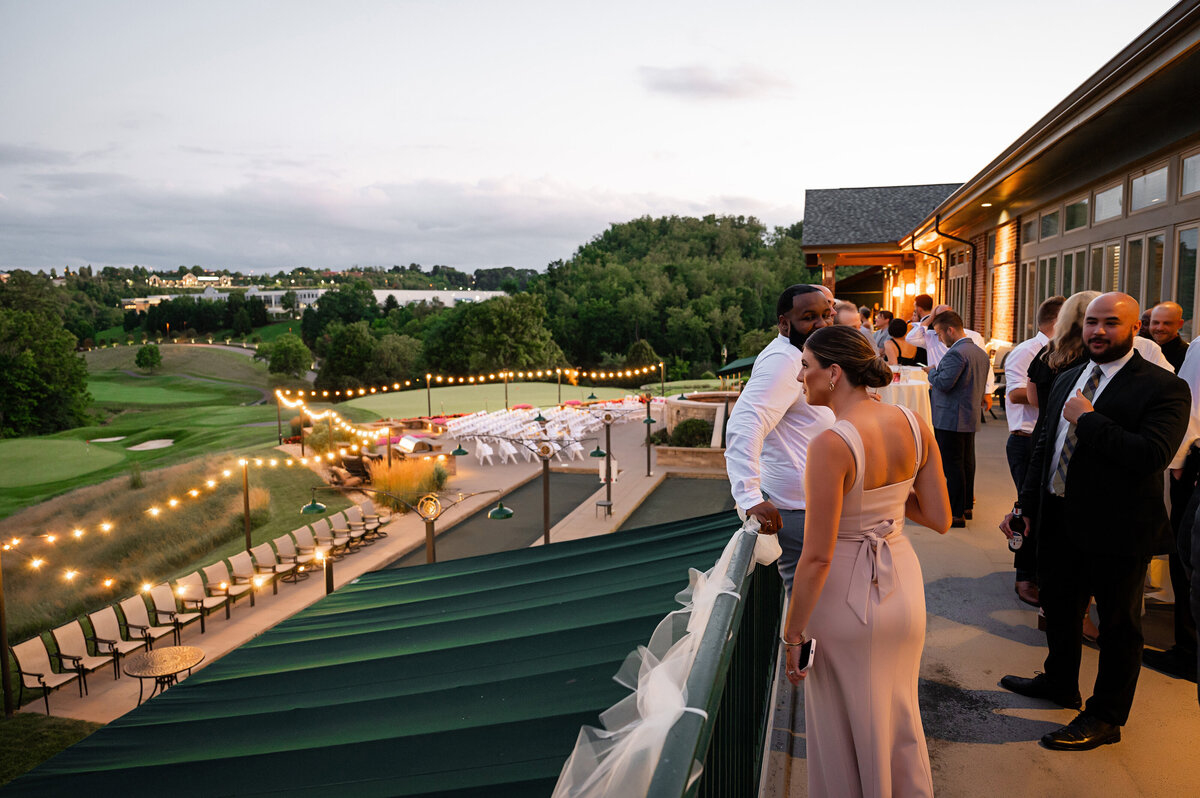 guests overlooking the southpointe golf club canonsburg in the evening at the wedding reception
