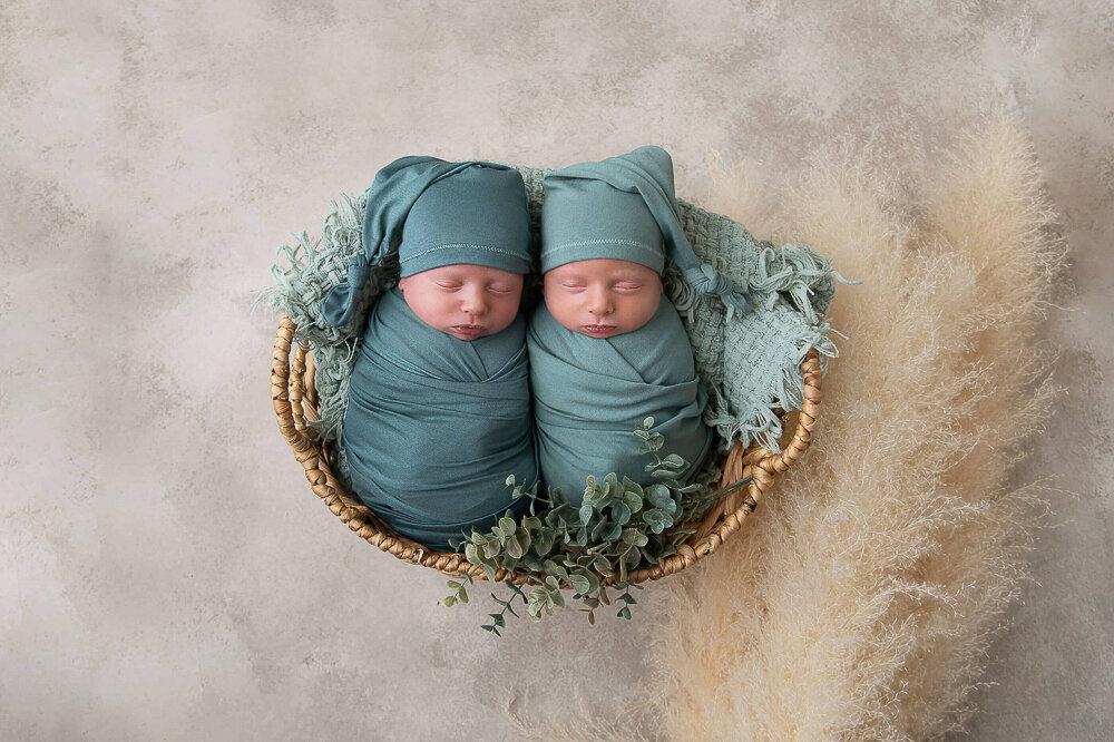 Twin boys wrapped in green for their newborn photography session in Hamilton, Ontario.
