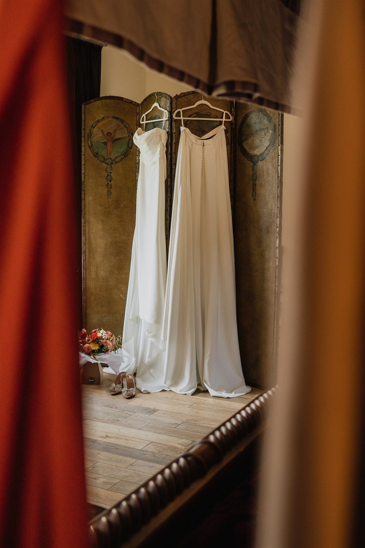 A wedding dress is photographed hanging in the bridal suite at Logie Country House.