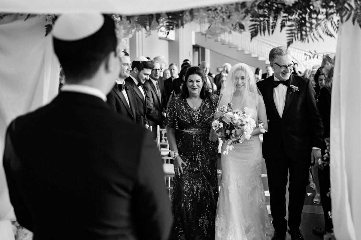 Bride and groom walking down aisle to show planning a wedding in chicago