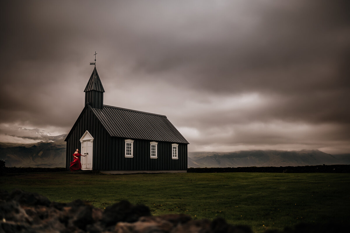 Kristen Vann running towards the Black church in Budir Iceland