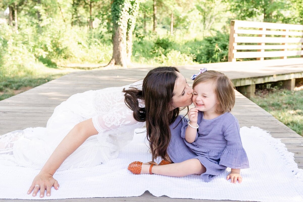 mom kissing daughter taken by a family photographer in Ashburn, Virginia