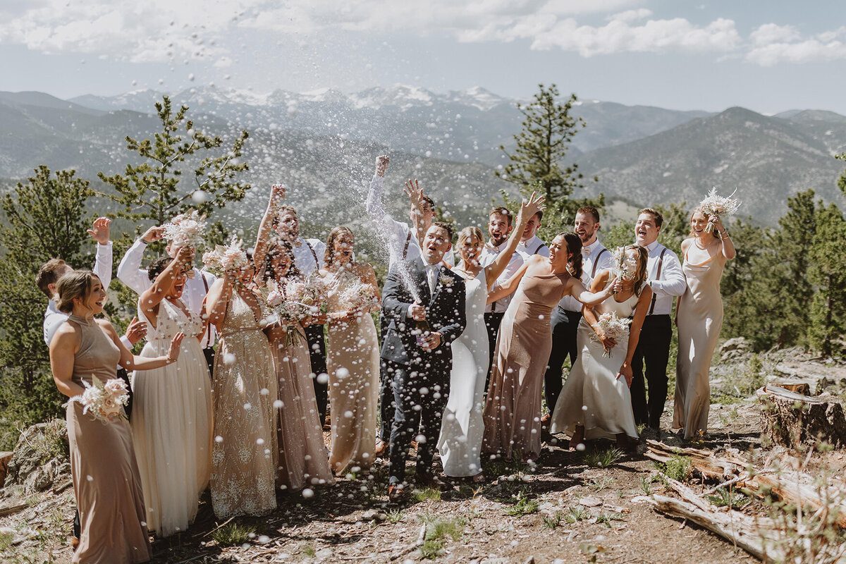 bridal party pops champagne