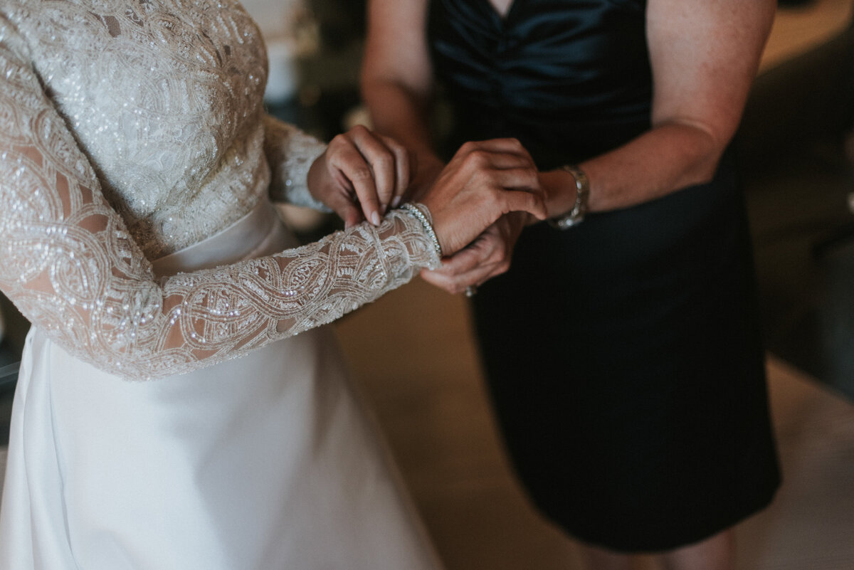mother giving bride a bracelet on
