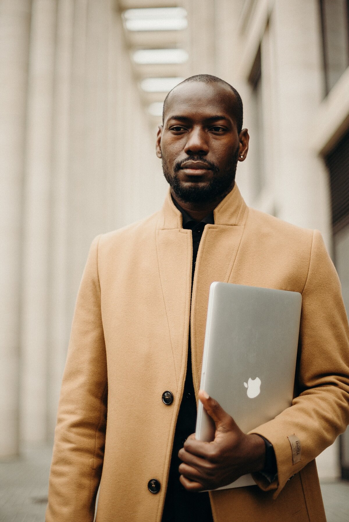 man-holding-macbook-pro-3206168