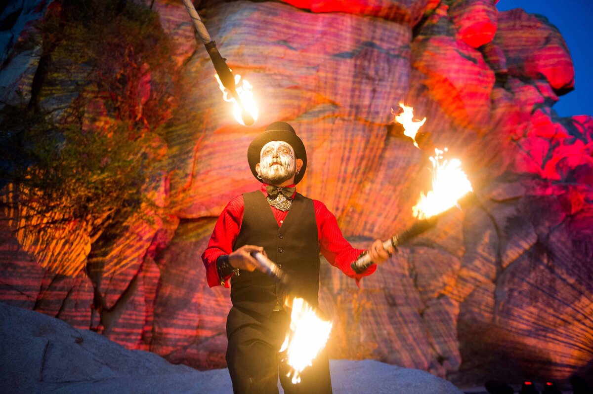An entertainer juggles firs torches for meeting entertainment.