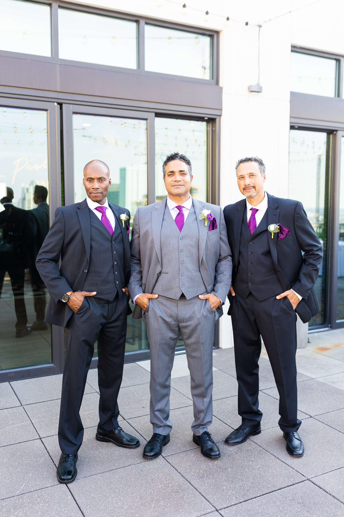 Groom with groomsmen wearing suits from Mens Warehouse
