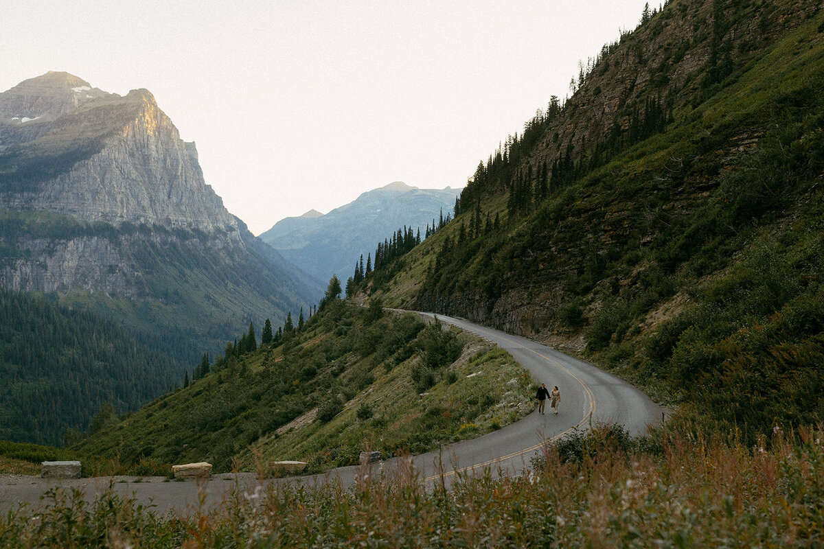 Couple running on Going to the Sun Road in Glacier National Park