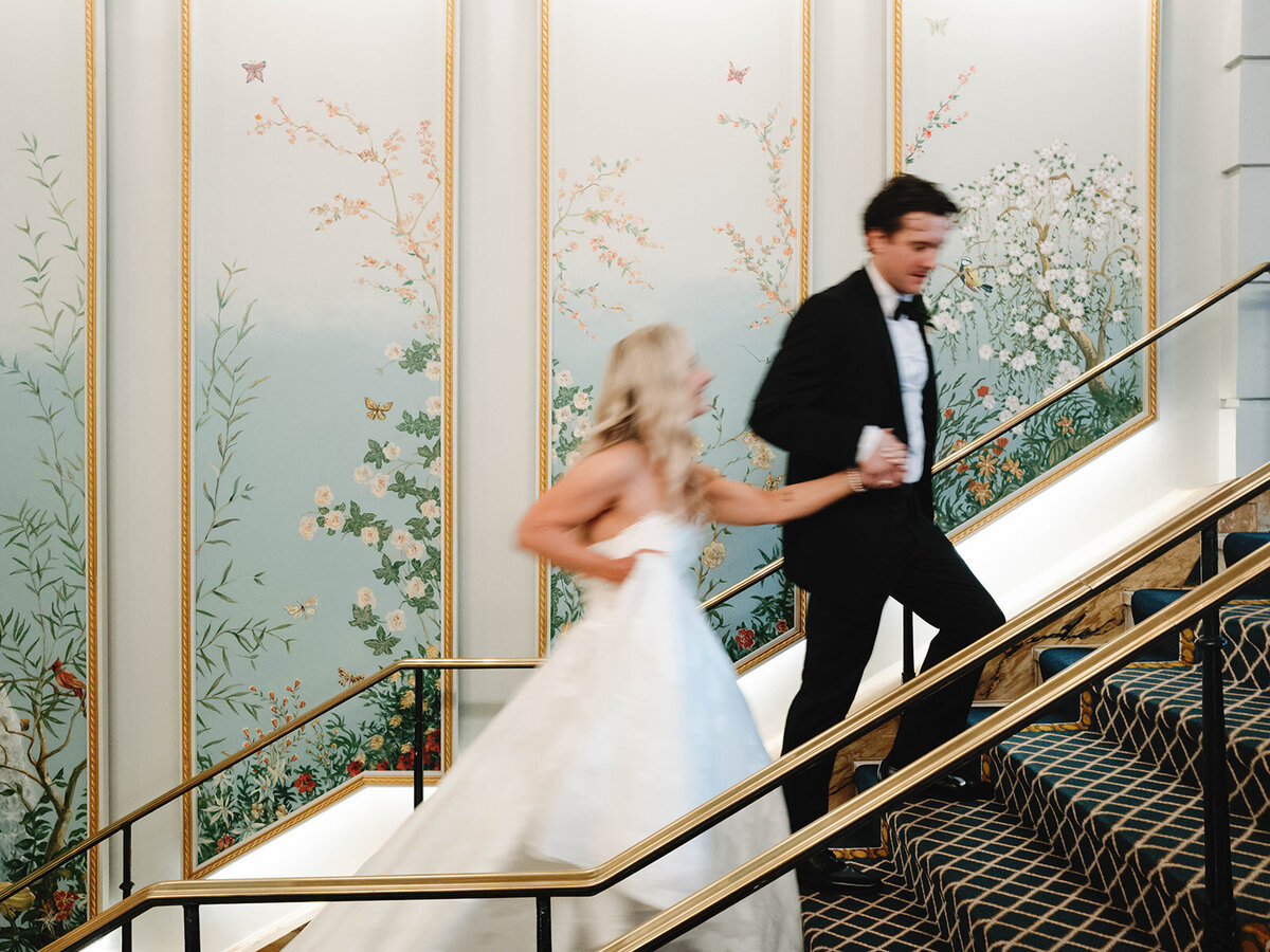 Couple walk up the Peacock Alley stairs at the Willard Intercontinental. 