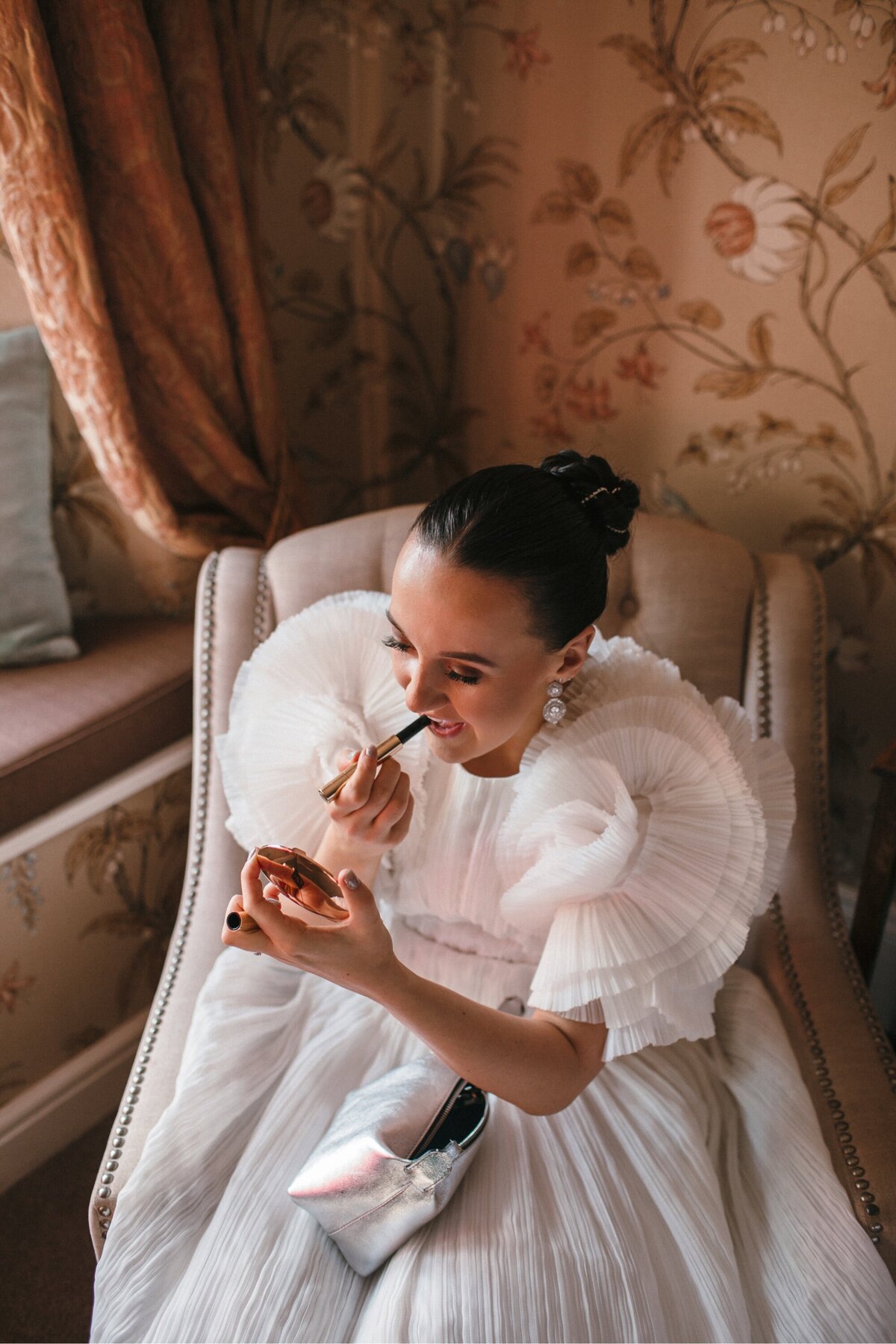 bride applying lipstick 