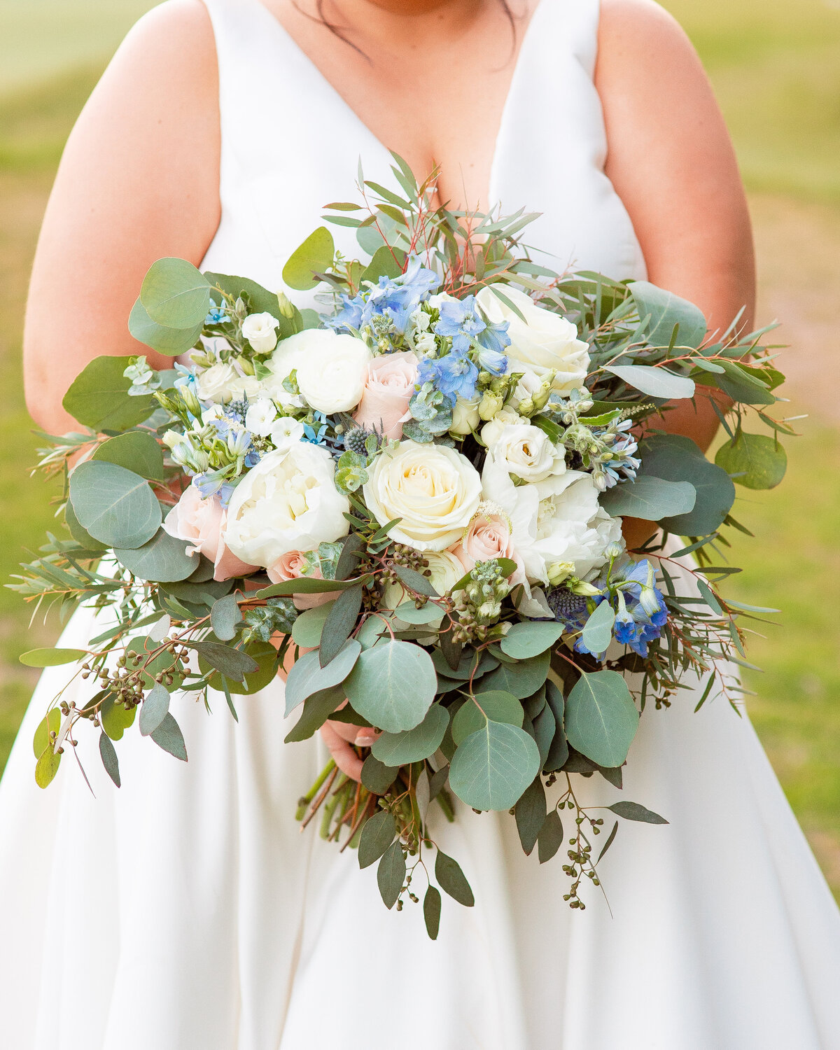 Bride holds her wedding bouquet.