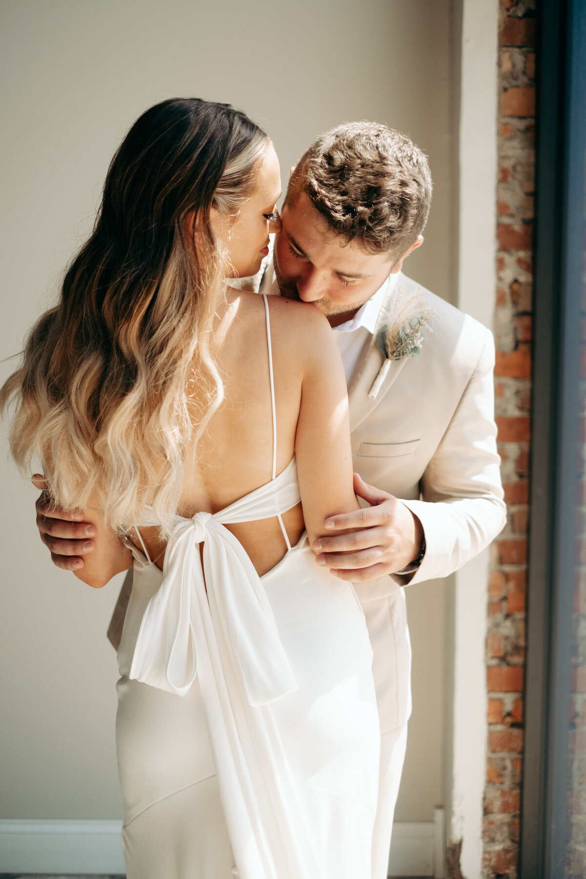 Bride and Groom in satin bow wedding dress