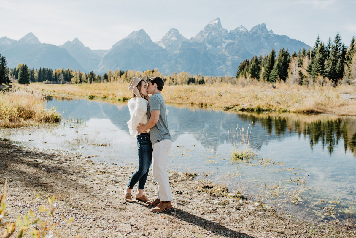 Photographers Jackson Hole capture couple kissing during forest engagements