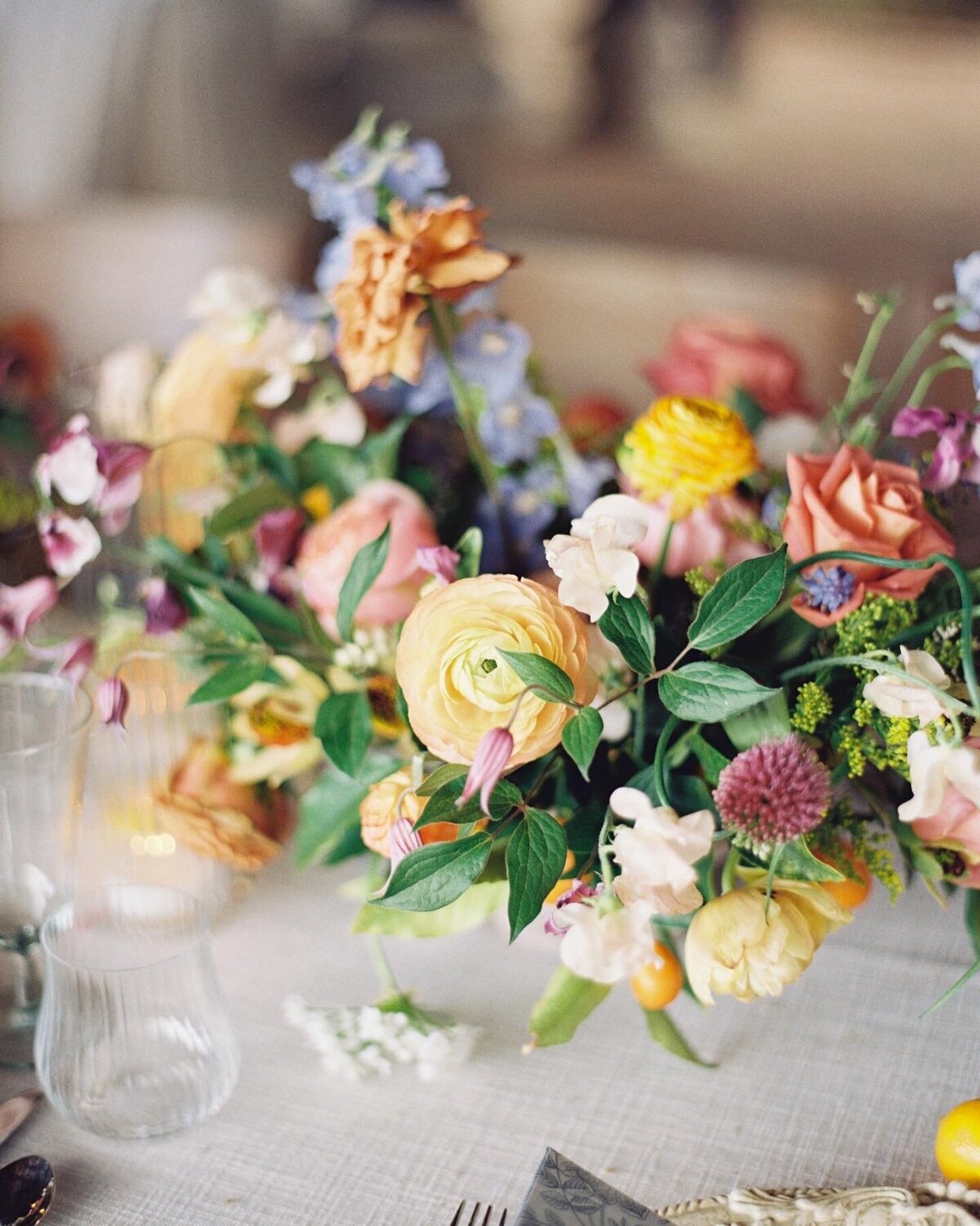 A vibrant floral arrangement inspired by the rich tones of Tuscany, featuring lush greenery and deep, earthy blooms, beautifully captured on film by Morgan Alysse, Louisiana film photographer.