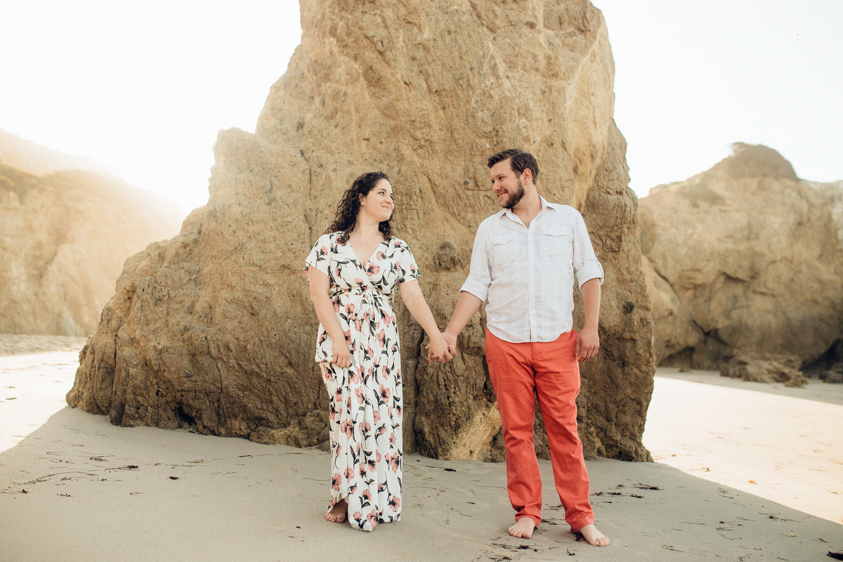 Engagement Photograph Of  Man And Woman Staring At Each Other While Holding Hands Los Angeles