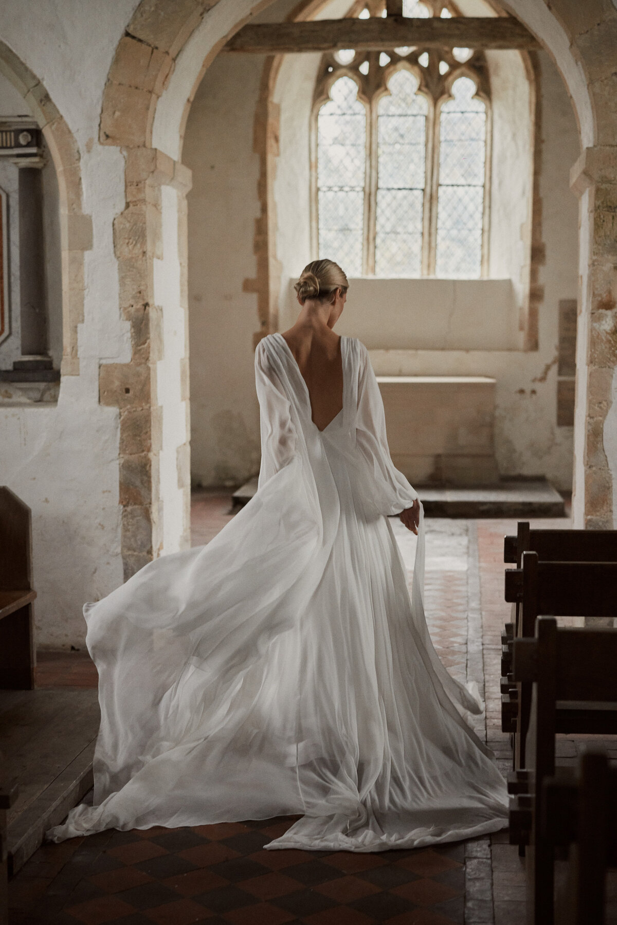 Georgette silk wedding dress by british bridal designer worn by bride in chapel