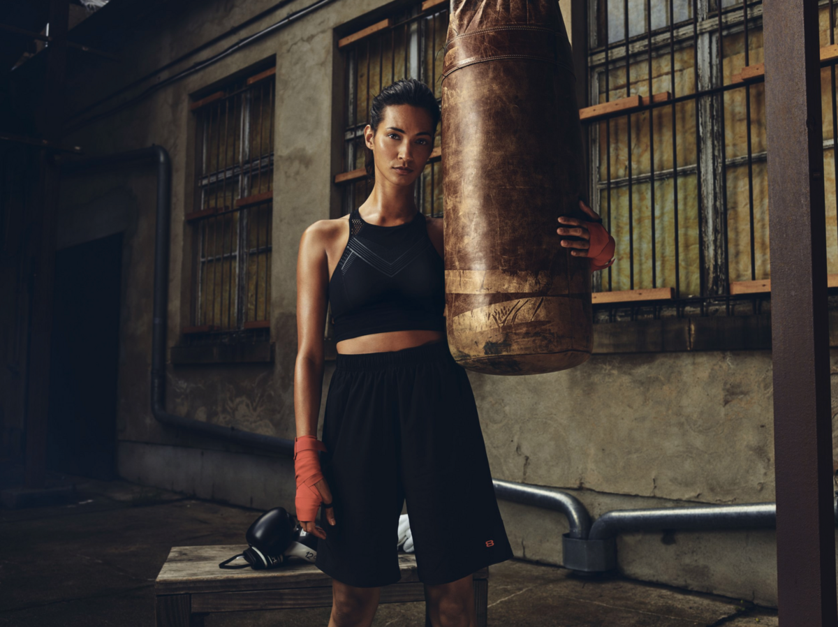 A single-source-lit portrait in a stylized indoor setting.