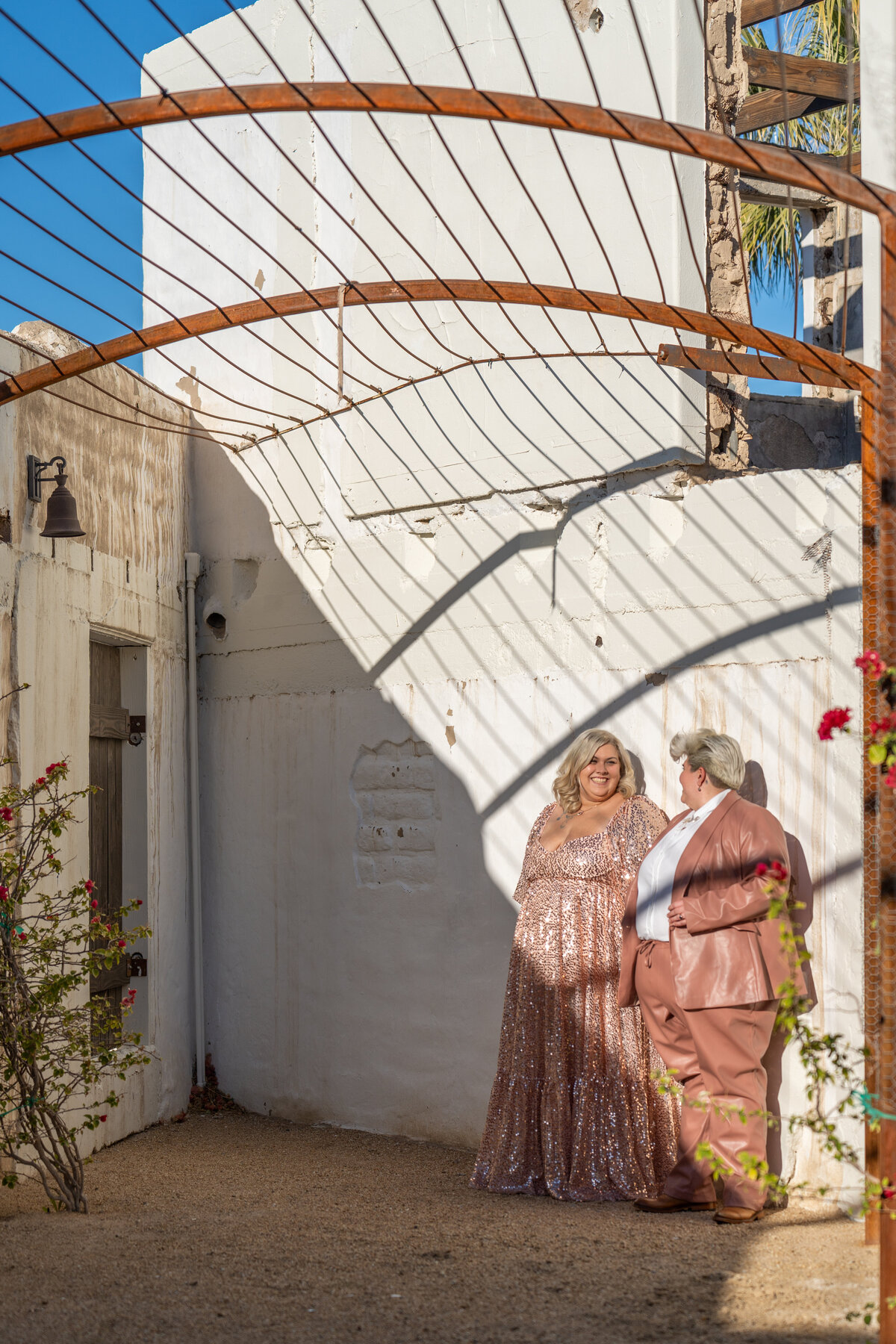 A couple standing together with shadows casting over them