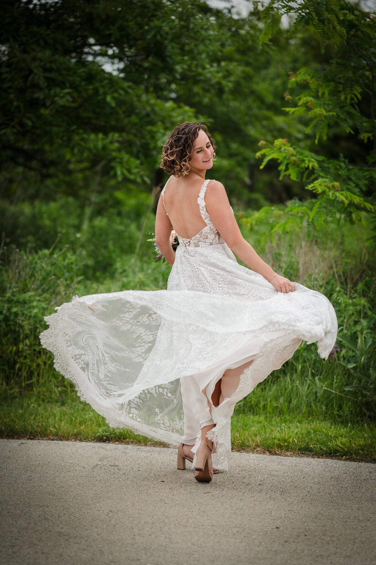 A bride spins around outside